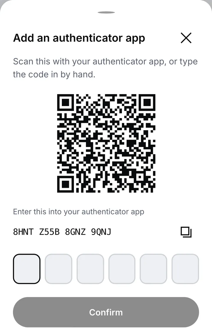The Add an authenticator app sheet: a QR code to scan, the same key to type in by hand, six boxes for the code the app shows, and the Confirm button
